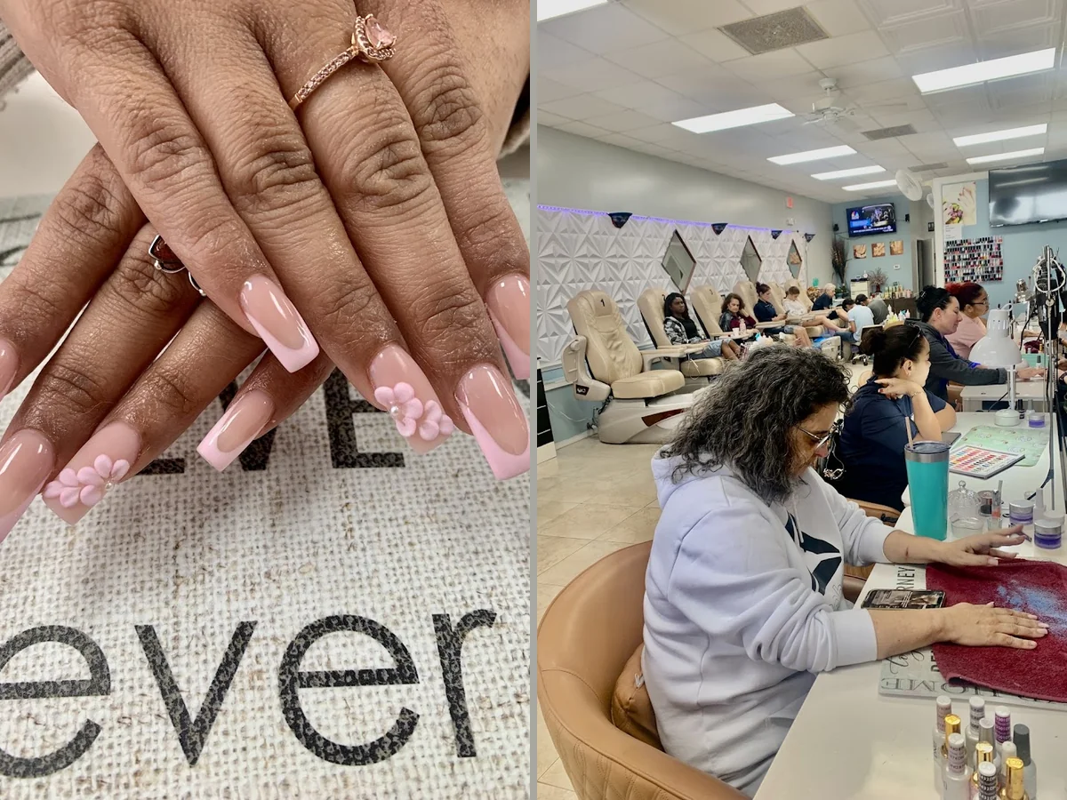 Nail technician shaping acrylic nails at a salon table